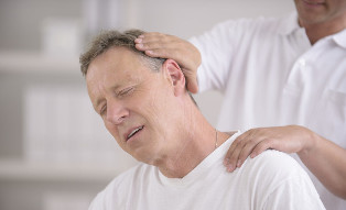 A man with neck osteochondrosis during the reception of a manual masseur